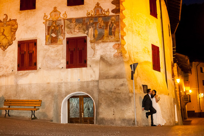 just married couple pose in a small mountain village during a photo shooting in Northern Italy