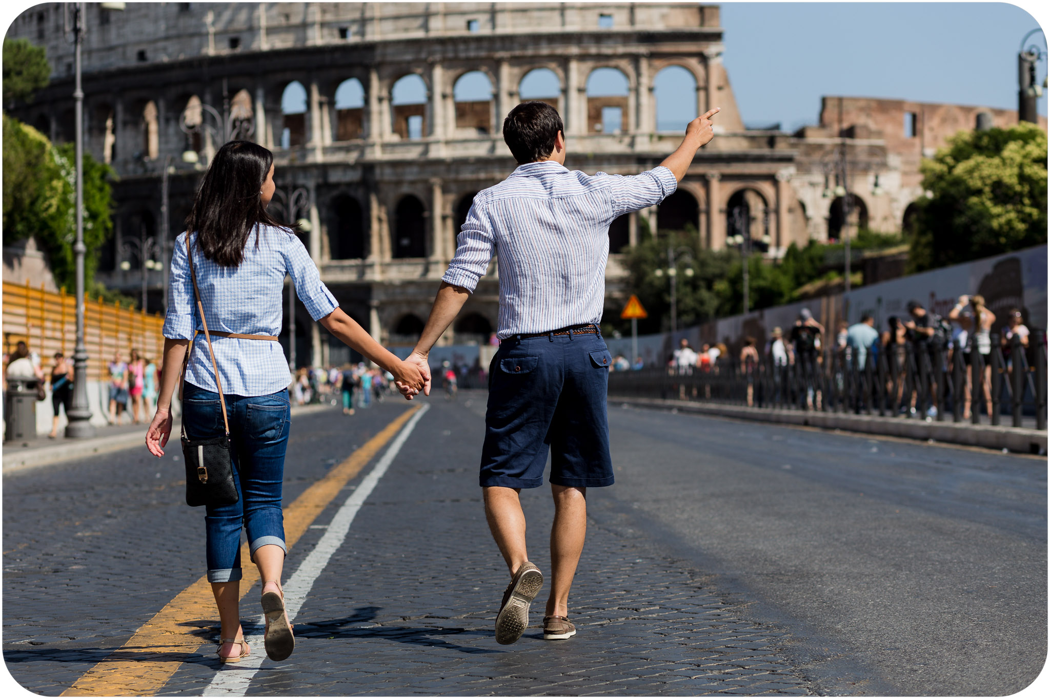 couple walking near the Colisseum during honeymoon photo service in Rome